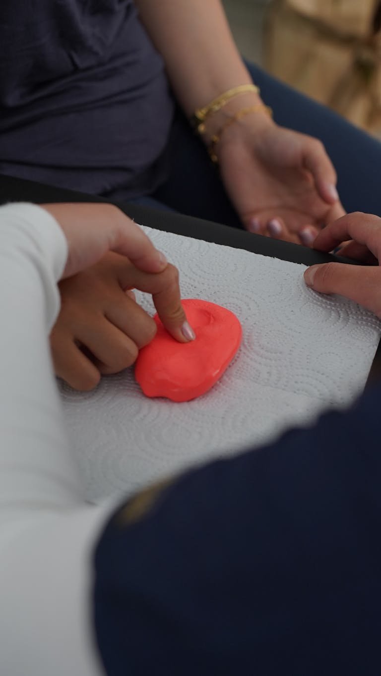 Children engaging in sensory play with clay, focusing on tactile stimulation. Fine Motor Skills